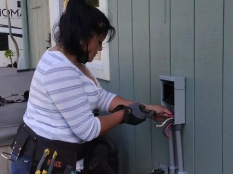 Licensed electrician wiring an exterior subpanel in Centennial